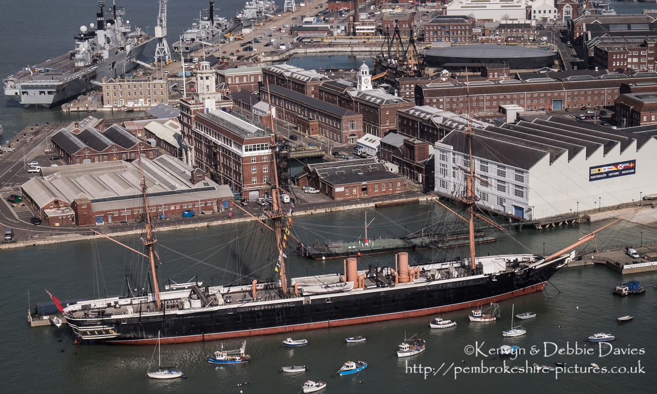 Built between 1859-61, The HMS Warrior was one of two armoured frigates (her sister ship was the HMS Black Prince) built in response to the French Napol?on, the first steam powered battleship in the world. She was the largest, most powerful and fastest ship of her day but soon became obsolete as maritime warfare equipment advanced. She is now docked in Portsmouth Harbour and has been restored as part of the National Maritime Fleet.<br/><br/>HMS Illustrious can been seen in the background (top left).