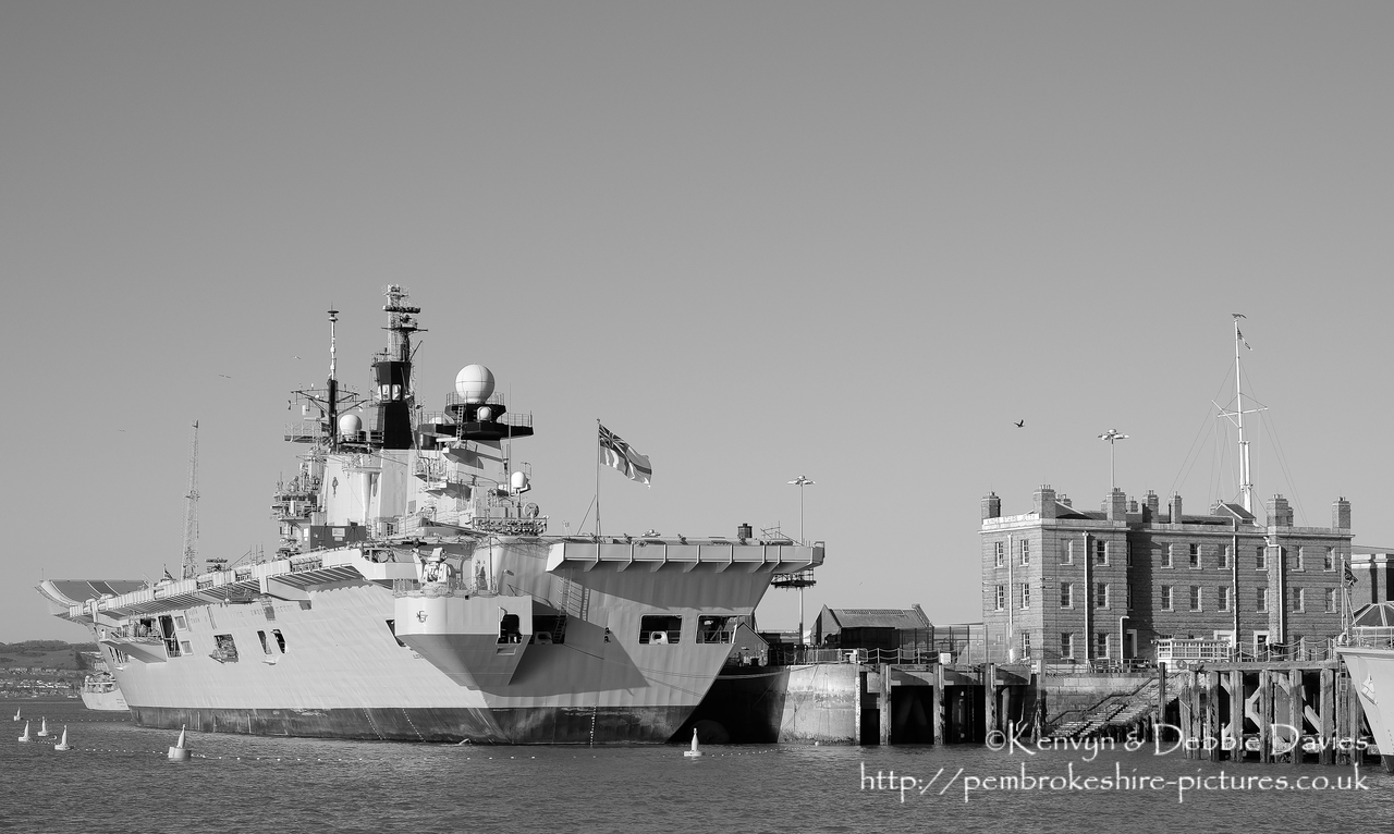 HMS Illustrious is an "Invincible" class light aircraft carrier, the middle of three built for the Royal Navy in the late 70s and early 80s (she was commissioned in 1982). Following the retirement of the Harrier VTOL aircraft in 2010 she became and helicopter carrier and is the oldest (as of 2014) serving ship in the Royal Navy. We were lucky to see her before her final deployment following which she will be de-commissioned and preserved for the nation.