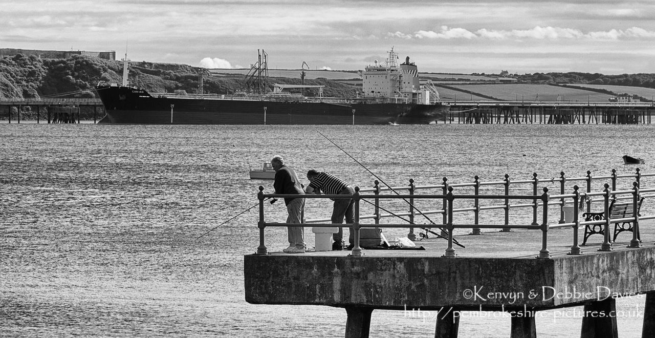 Fishing in Milford with the tanker Cariad in the background