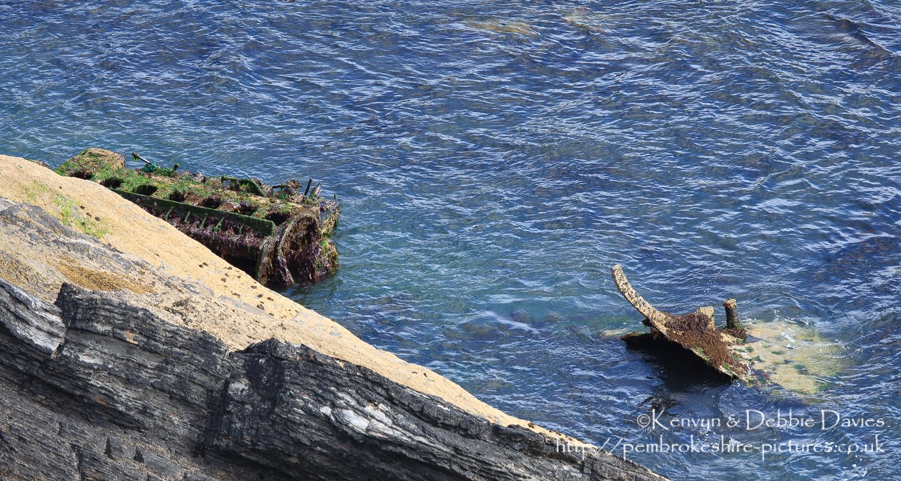 Along the coastal path a couple of miles north of Solva is the site of the wrecks of the Vernicos Alexia, Vernicos Georgios and Vernicos Barbara IV. I  1981 the Alexia was towing the Georgios and Barbara when it suffered engine problems. It's anchors failed to hold and all three tugs were swept ashore and wrecked. An engine block and a few scraps is all that remains although more can be seen at low tide.