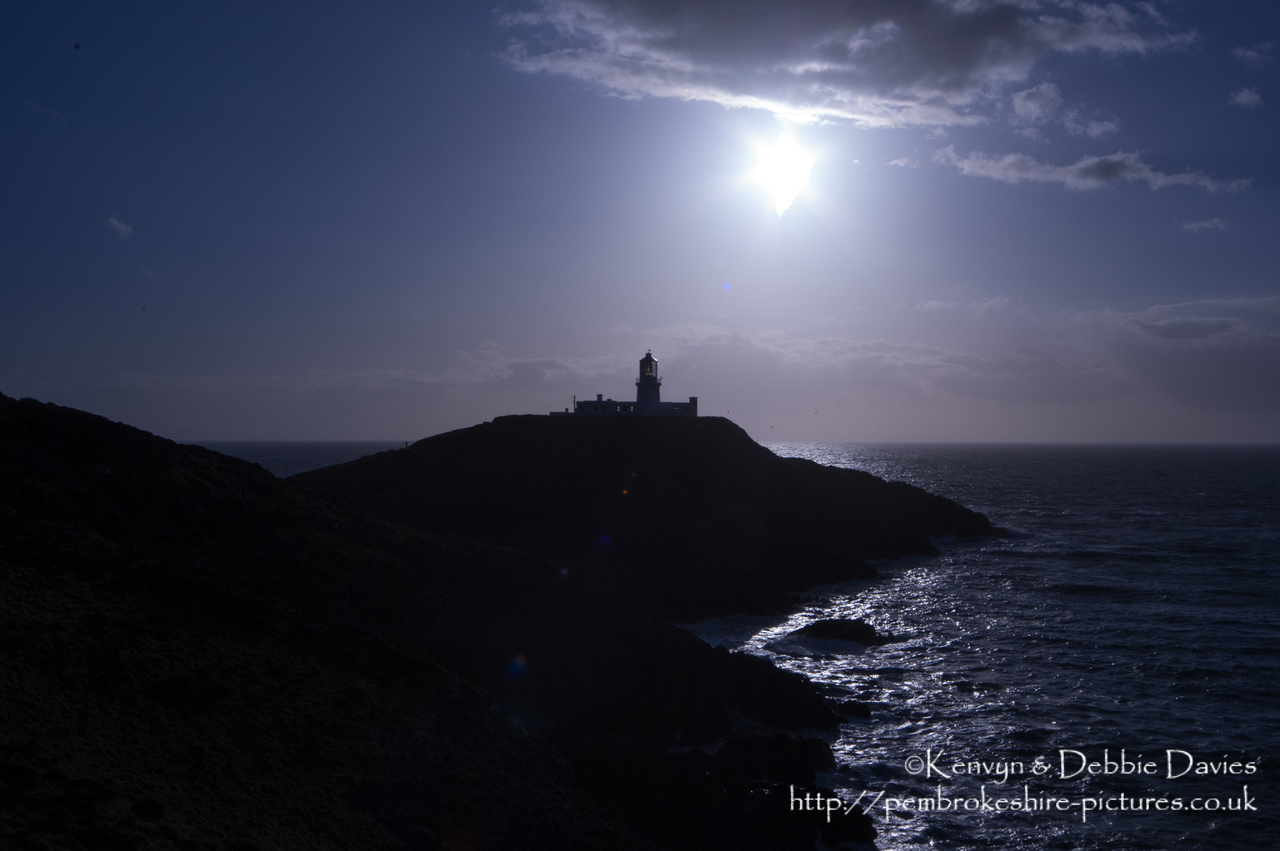 Strumble Head Lighthouse is built on Ynysmeicl (St. Michael's Island), an islet to the west of Fishguard, separated from the mainland by a very narrow gap.<br/><br/>The station was built in 1908 by Trinity House for the greater safety of sea traffic between Ireland and Fishguard Harbour which is located behind cliffs and a breakwater three miles to the east. The new light also formed a link with the existing South Bishop light, 18 miles to the south-west. This stretch of coast is very dangerous, and some 60 vessels are known to have been lost along it in the 19th Century alone.