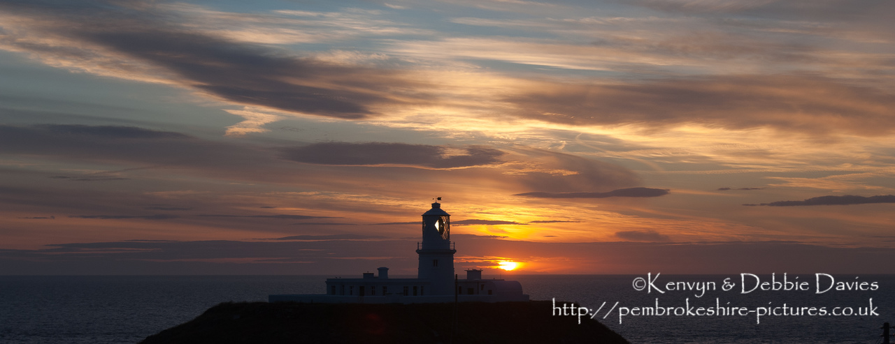 Strumble Head Lighthouse is built on Ynysmeicl (St. Michael's Island), an islet to the west of Fishguard, separated from the mainland by a very narrow gap.<br/><br/>The station was built in 1908 by Trinity House for the greater safety of sea traffic between Ireland and Fishguard Harbour which is located behind cliffs and a breakwater three miles to the east. The new light also formed a link with the existing South Bishop light, 18 miles to the south-west. This stretch of coast is very dangerous, and some 60 vessels are known to have been lost along it in the 19th Century alone.