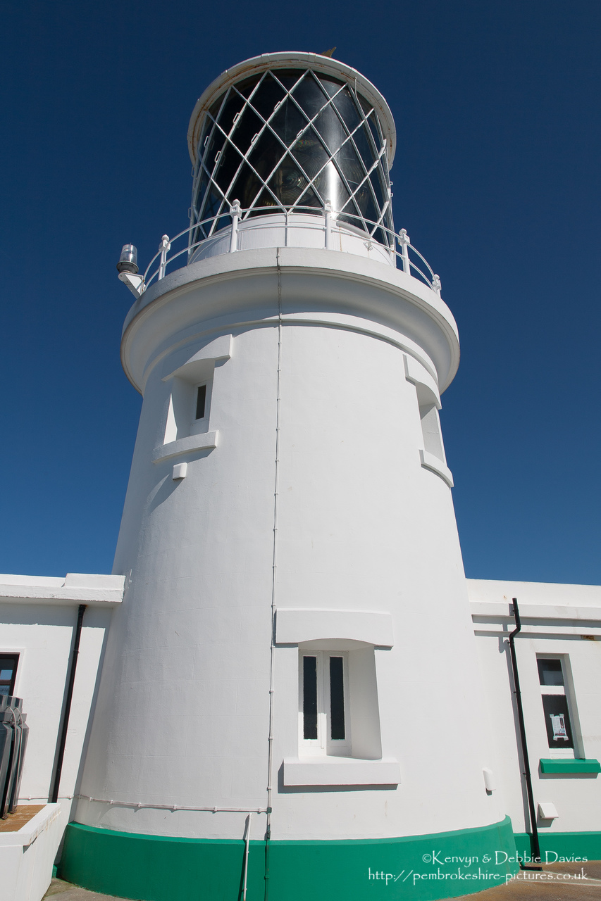 Strumble Head Lighthouse is built on Ynysmeicl (St. Michael's Island), an islet to the west of Fishguard, separated from the mainland by a very narrow gap.<br/><br/>The station was built in 1908 by Trinity House for the greater safety of sea traffic between Ireland and Fishguard Harbour which is located behind cliffs and a breakwater three miles to the east. The new light also formed a link with the existing South Bishop light, 18 miles to the south-west. This stretch of coast is very dangerous, and some 60 vessels are known to have been lost along it in the 19th Century alone.