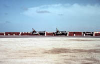 Hawker Hunter FR10s of 1417 Flight at RAF Khormaksar circa 1966   Protected by stacked 40 gallon drums of "fresh" water.
