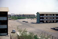 Courtesy of Bob Stewart (many thanks Bob): This is a view towards Khormaksar main camp from the "Dhobi Lines" flats. The building on the middle distance is where I lived as a 9 year old. The big roundabout thing centre frame (home of a myriad of stray cats) was opposite the main entrance and guardhouse to the flats. The photo is taken towards the officers flats from the other ranks accommodation, roundabout divided the accommodation otherwise I think flats were the same. Note the flats were outside the main  gate to the base and us kids had to walk alongside the road for 100 yards or so to get into the main base and school.